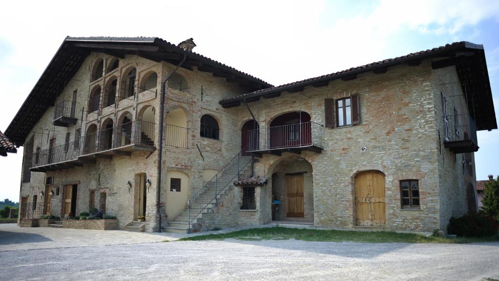 a large stone building with stairs on the side of it at Casapecchenino in Dogliani