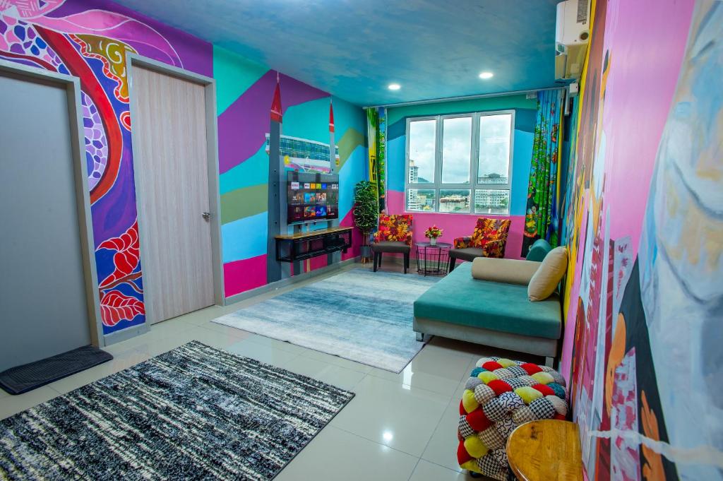 a colorful living room with a couch and a window at The Arts Smart Home Terengganu in Kuala Terengganu
