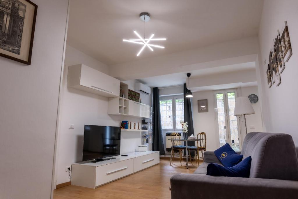 a living room with a couch and a tv at La Dolce Roma - Relax & Comfort in Rome