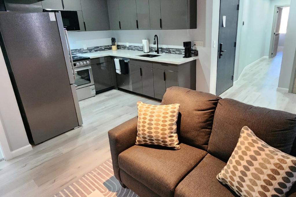 a living room with a couch and a kitchen at Peaceful Midtown Apartment with Gym and Parking in Tulsa