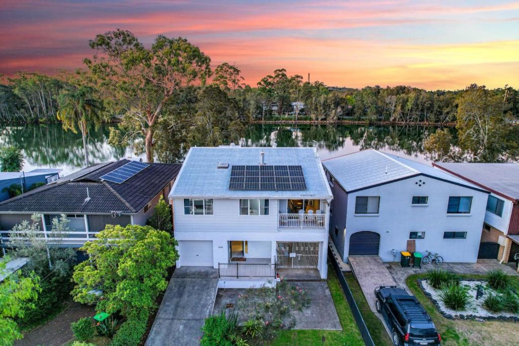 an aerial view of a house with solar panels on the roof at River Retreat in Dora Creek