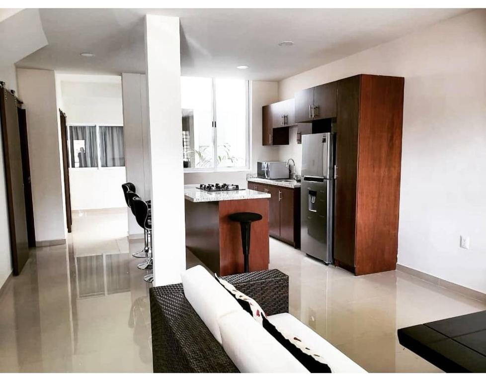 a kitchen with a couch and a table in a room at Casa Soly in Mazatlán