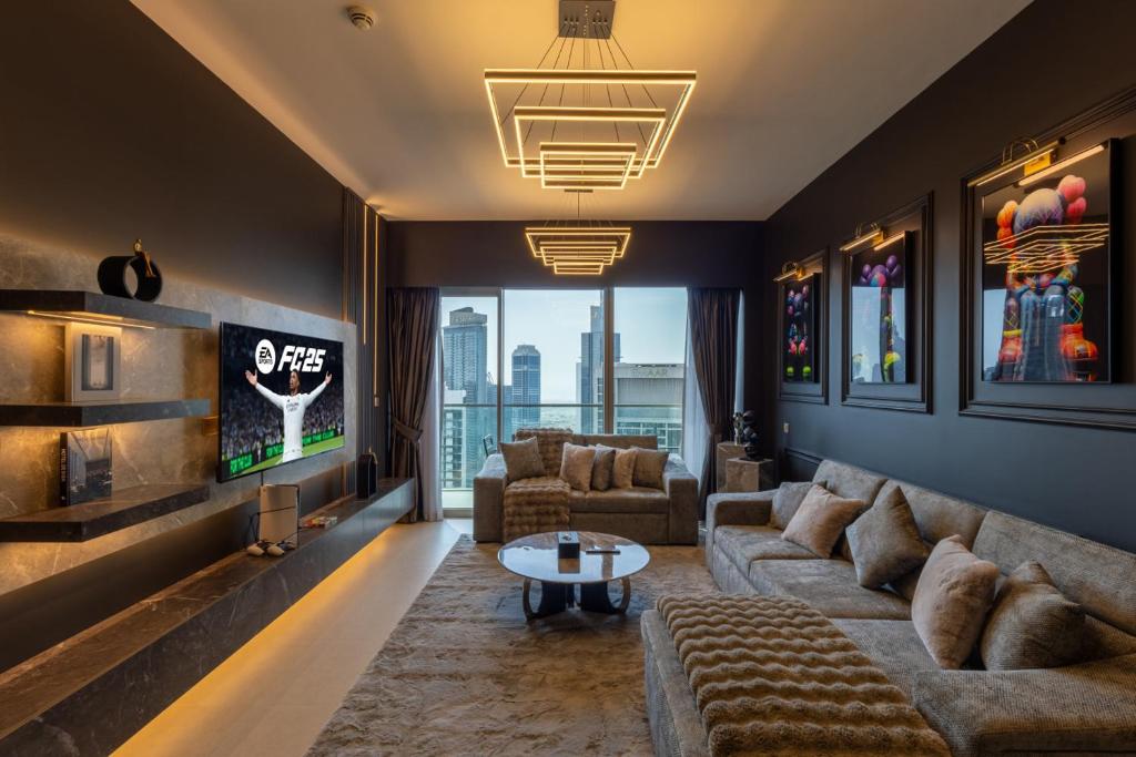 a living room with a couch and a tv at Luxury 1-Bedroom, High-Floor, Skyline Views in Dubai