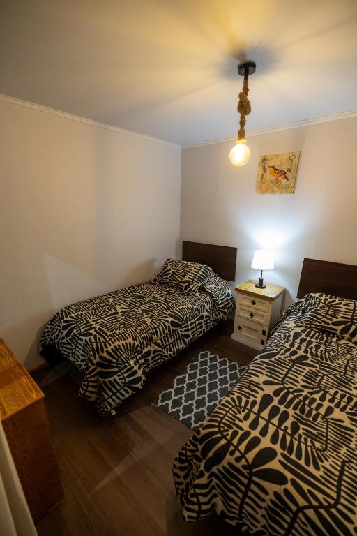 Postel nebo postele na pokoji v ubytování Hostal Ruta del Desierto
