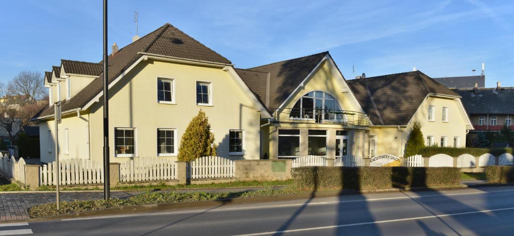 a white house with a black roof at Pension 101 Dubá in Dubá