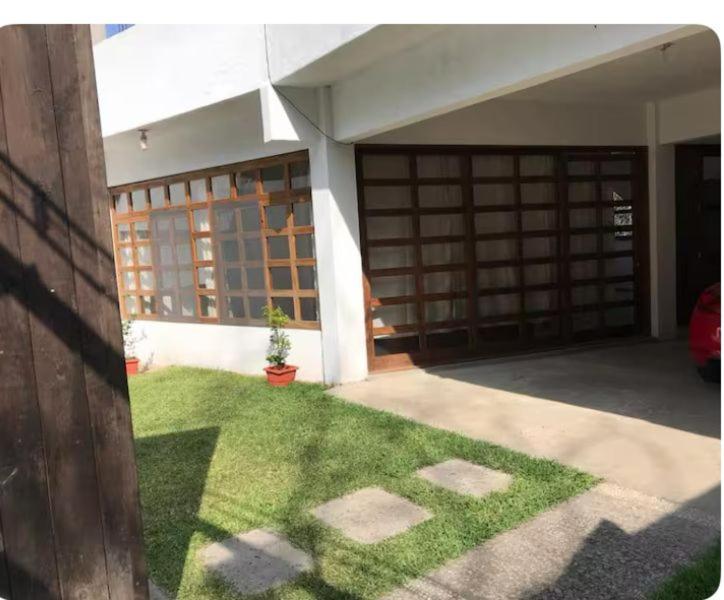 a front yard of a house with a door and grass at MI CASA EN TEPOZTLAn in Tepoztlán