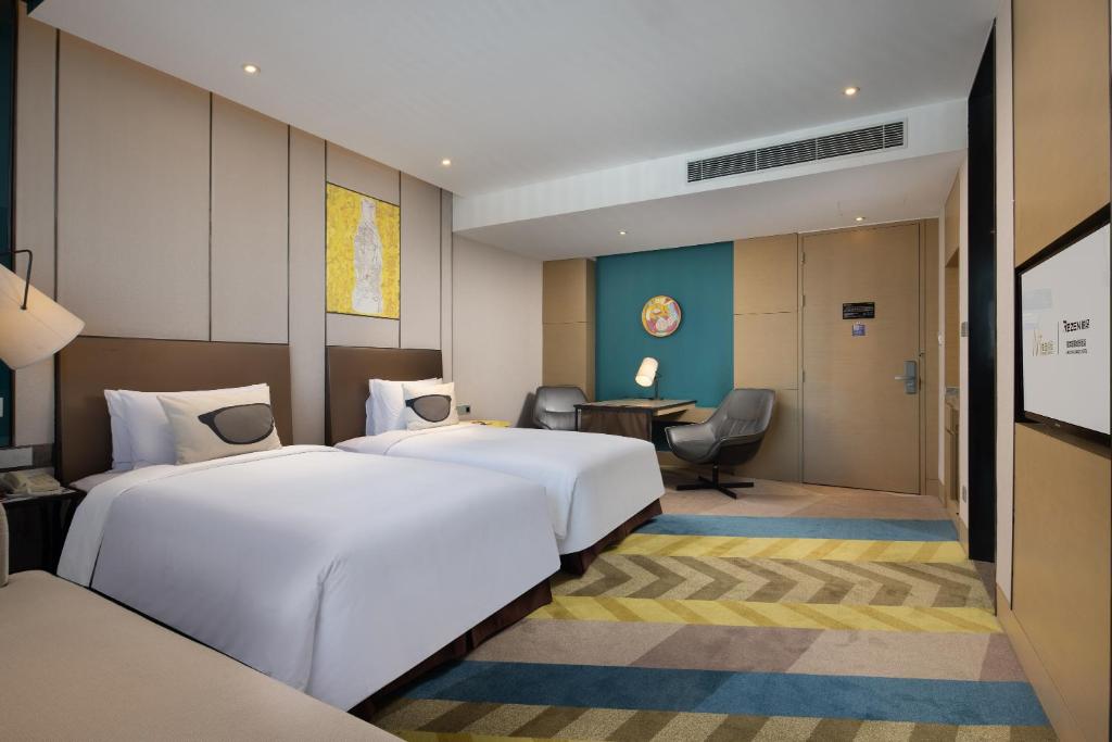 Postel nebo postele na pokoji v ubytování MiniMax Premier Hotel Shanghai Hongqiao