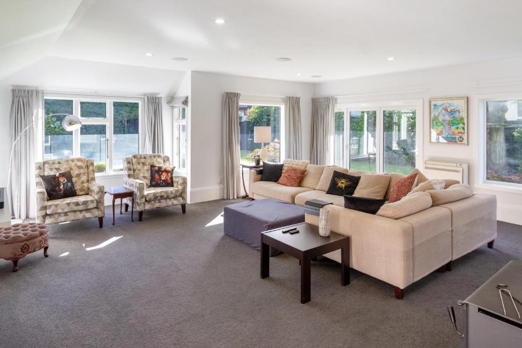 a living room with a couch and two chairs at Grand 5-Bedroom Villa in Fendalton in Christchurch