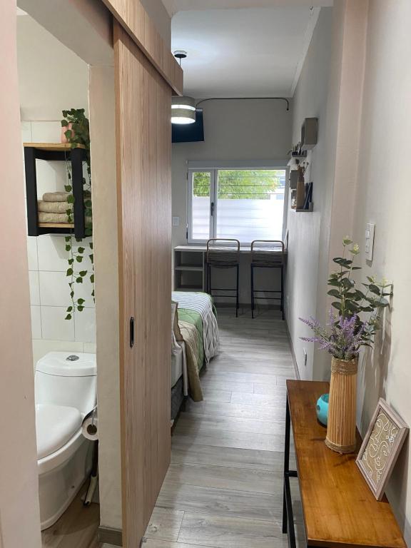a room with a bathroom with a toilet and a sink at Departamentos Pura Vida in General Roca