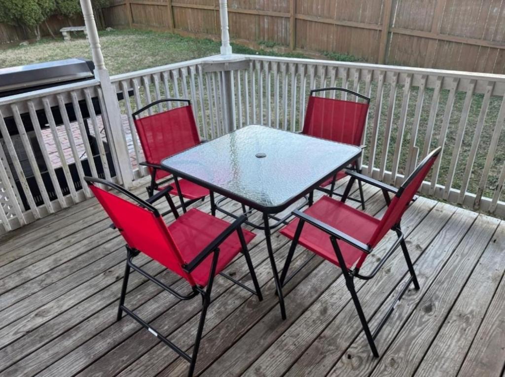 a table and four chairs on a deck at La Vergne hottub hospital mancave 75in Tv in La Vergne