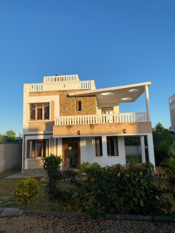 a large house with a balcony on top of it at Almond 7 in Gazi