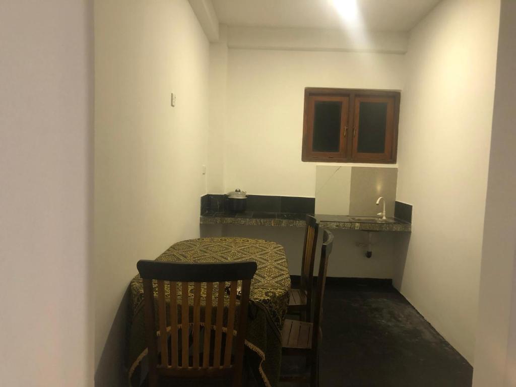 a small room with a table and a chair at Marine bay surf villa in Weligama