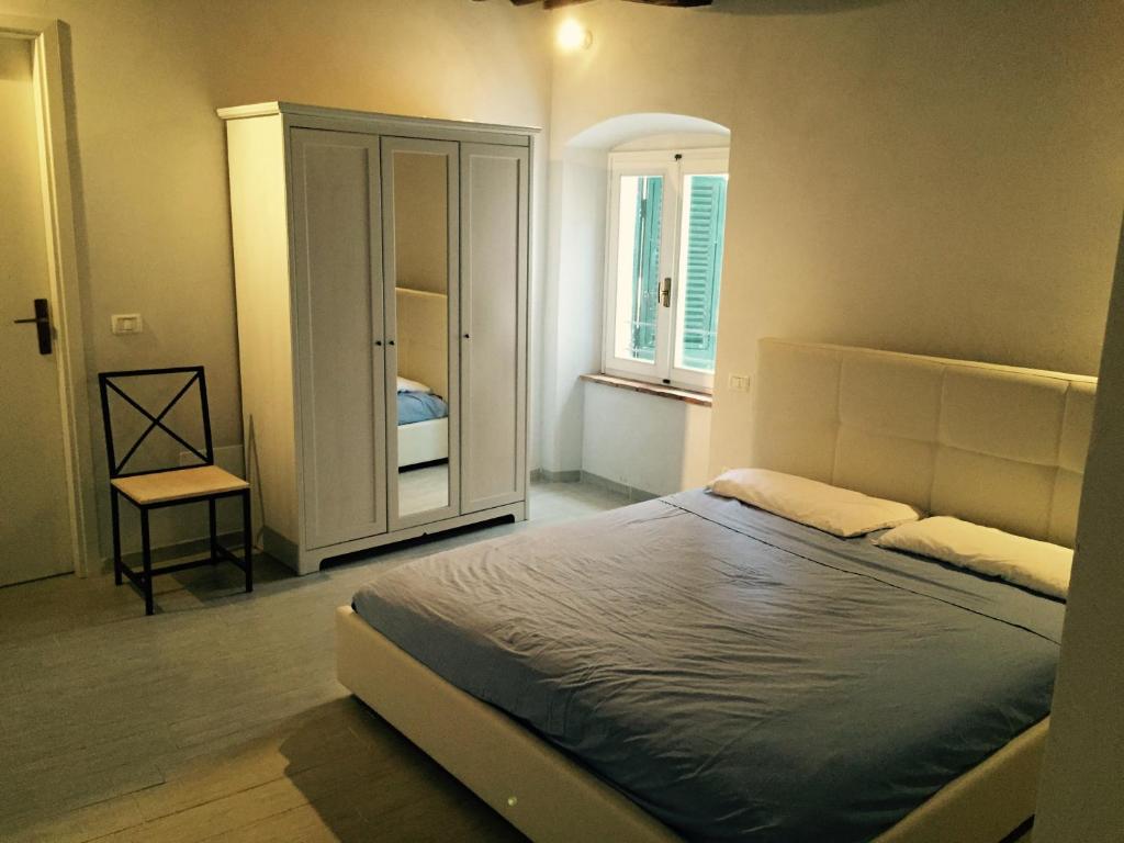 a bedroom with a large bed and a window at Appartamento Porto Azzurro in Porto Azzurro