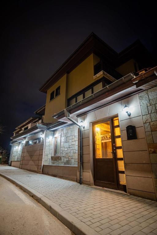a building with lights on the side of it at night at Къща за гости Карлък in Smolyan