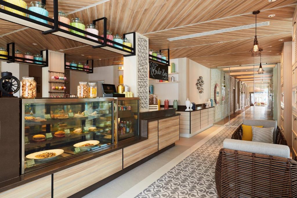a restaurant with a display case with food at Amari Koh Samui in Chaweng