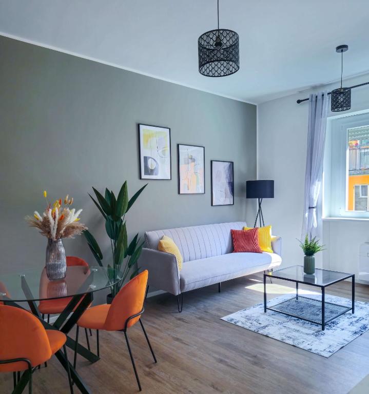 a living room with a couch and a table at Morgagni Suites in Bologna