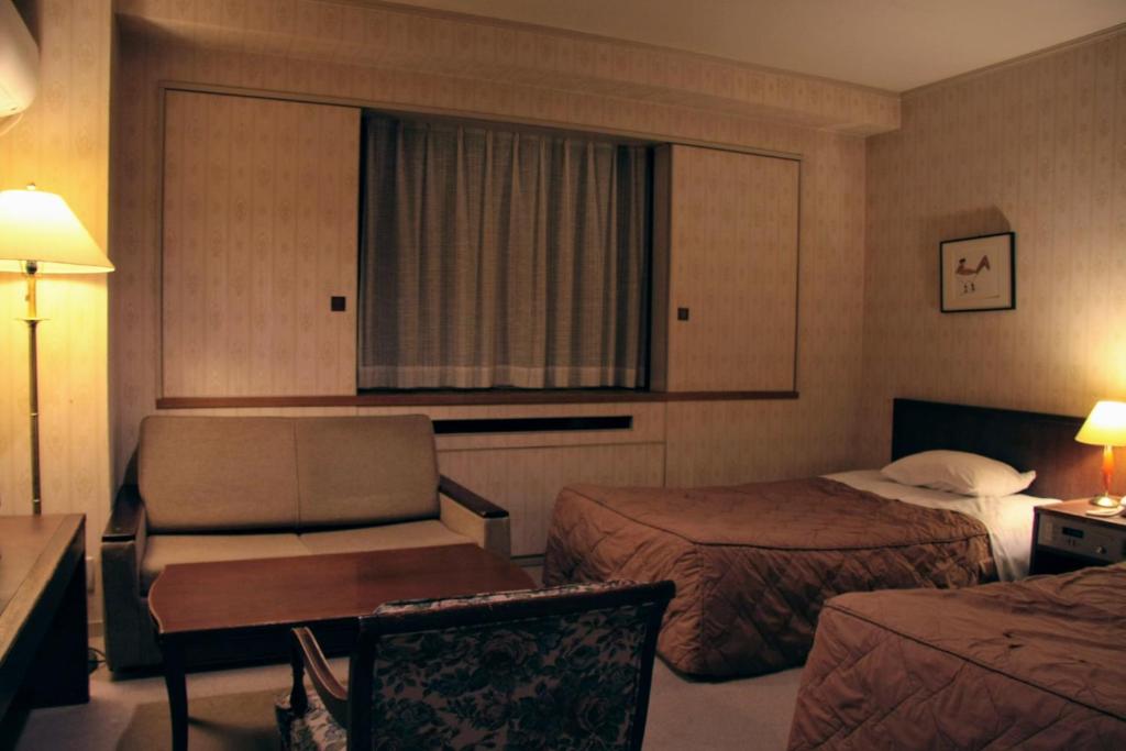 Postel nebo postele na pokoji v ubytování Kawaguchiko Hotel