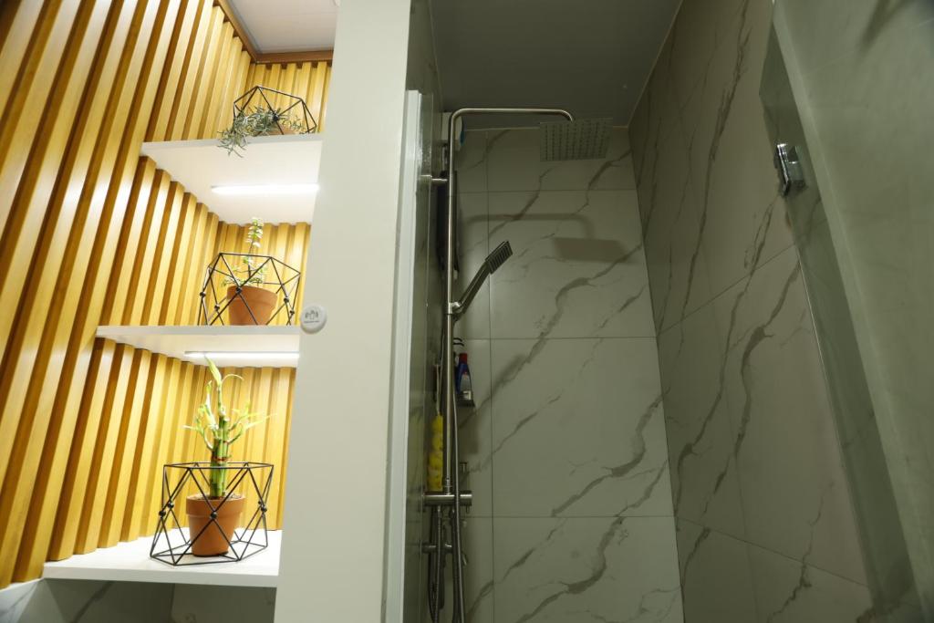 a bathroom with a shower with a glass door at La Joya Suite in Naga