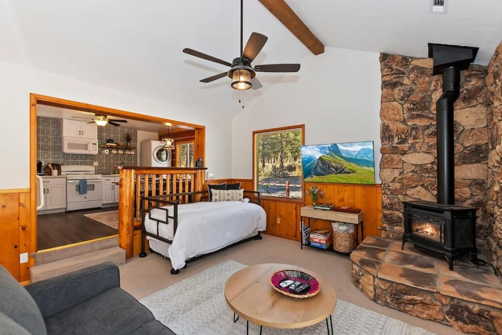 a living room with a couch and a fireplace at Brother Bear Cabin in Big Bear City