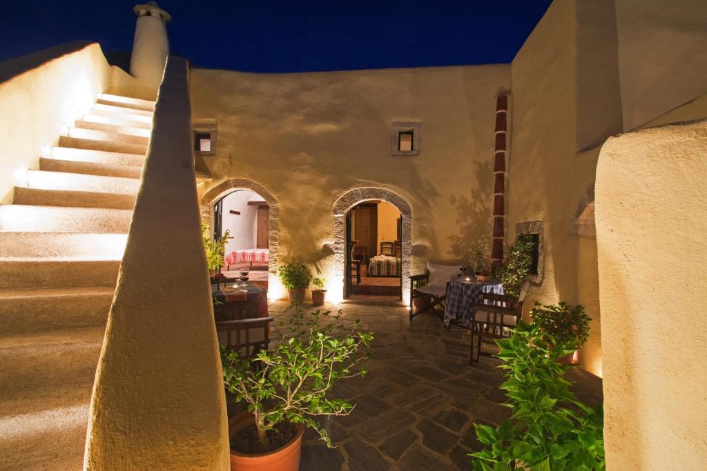 a courtyard with stairs and plants in a building at Abramis Rooms in Mitáta