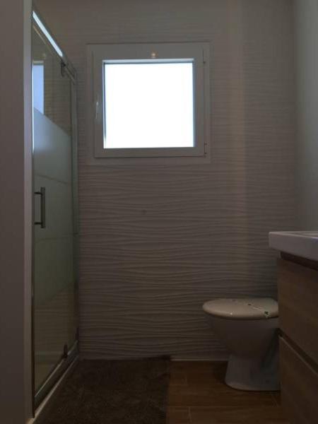 a bathroom with a toilet and a window at Villa MA&amp;VA in Lacanau-Océan