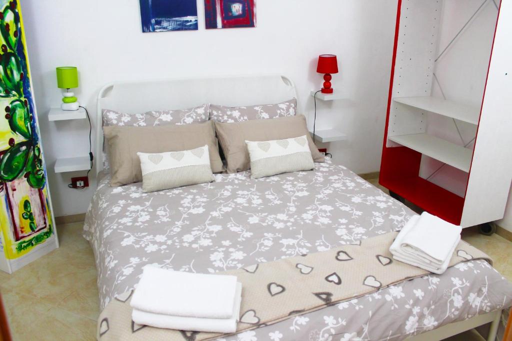 a small bedroom with a bed and a book shelf at Ariel Apartment Ortigia Siracusa in Siracusa