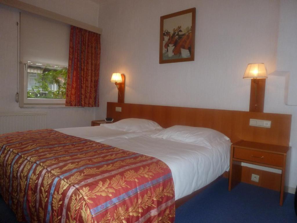 Postel nebo postele na pokoji v ubytování Hotel 'T Hert