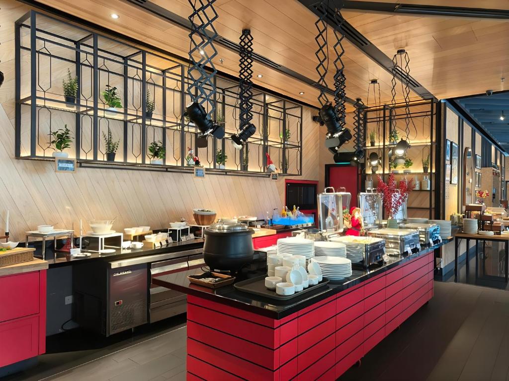 a kitchen with a counter with dishes on it at The Kuala Lumpur Journal Hotel in Kuala Lumpur