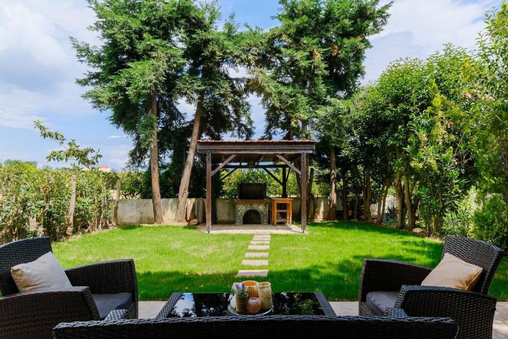 a backyard with a gazebo and a table and chairs at IOLI by halu! 3BD family house with private garden in Afitos