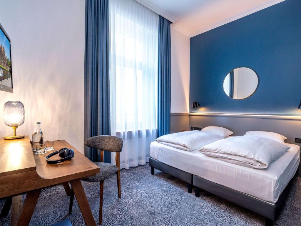 Postel nebo postele na pokoji v ubytování Mercure Hotel Luebeck City Center