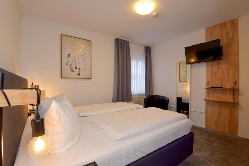 Postel nebo postele na pokoji v ubytování Hotel Wolke