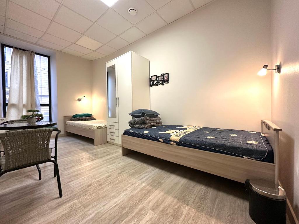 a bedroom with a bed and a desk in it at Room for rent at Centre, Riga in Rīga
