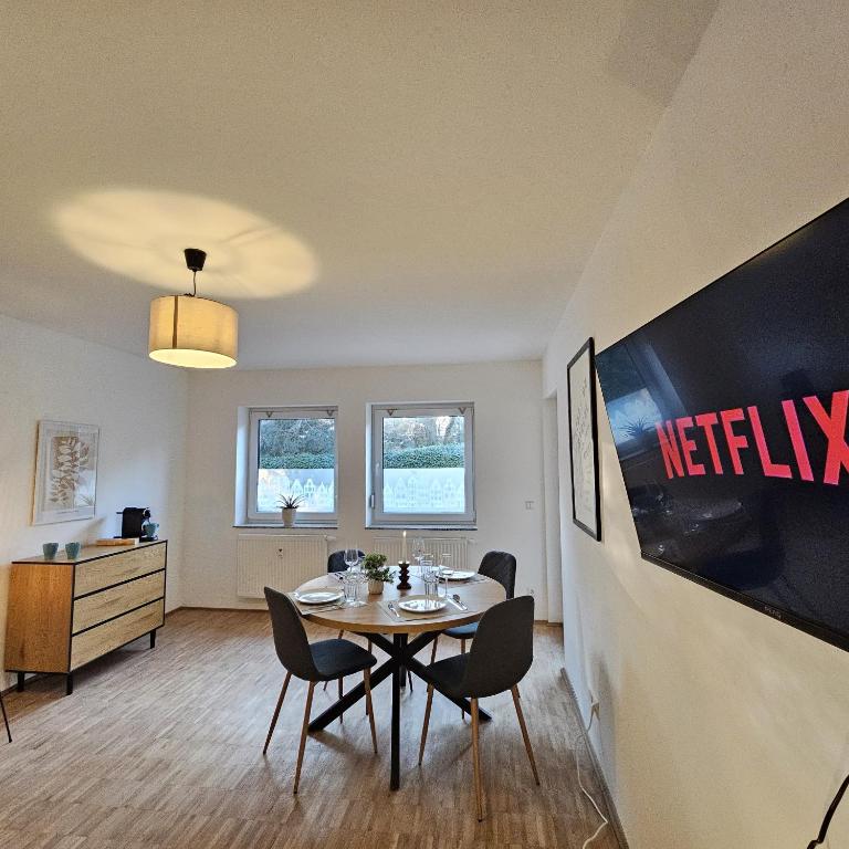 a dining room with a table and chairs at Urban Suites HBN in Heilbronn