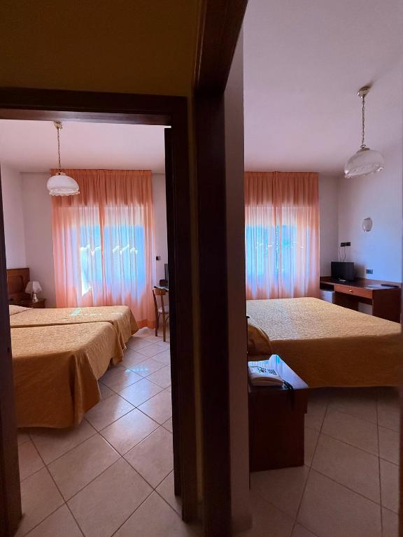 Postel nebo postele na pokoji v ubytování Grifone Hotel