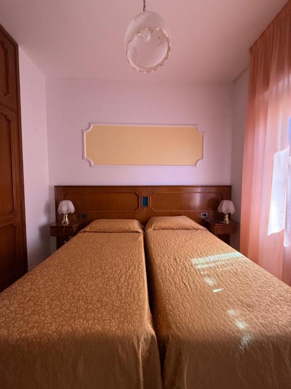 Postel nebo postele na pokoji v ubytování Grifone Hotel