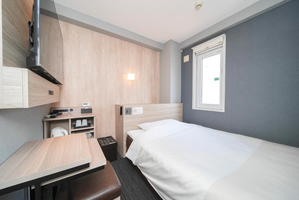 Postel nebo postele na pokoji v ubytování Super Hotel Hiroshima