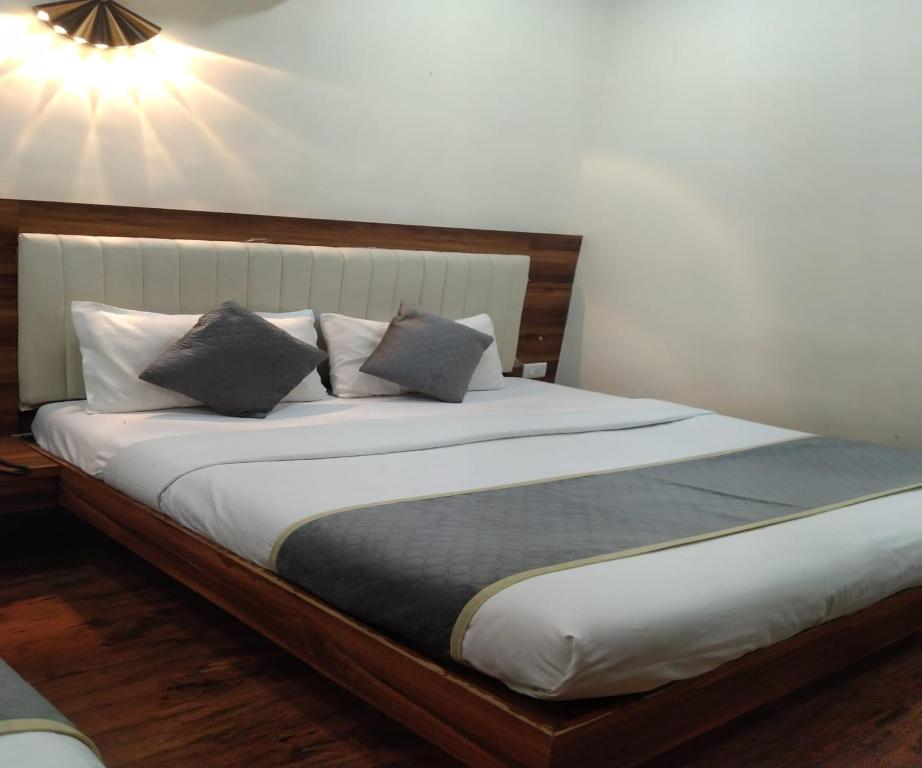 a bedroom with a large bed with two pillows at HOTEL AIR VIEW Near Airport in Mumbai