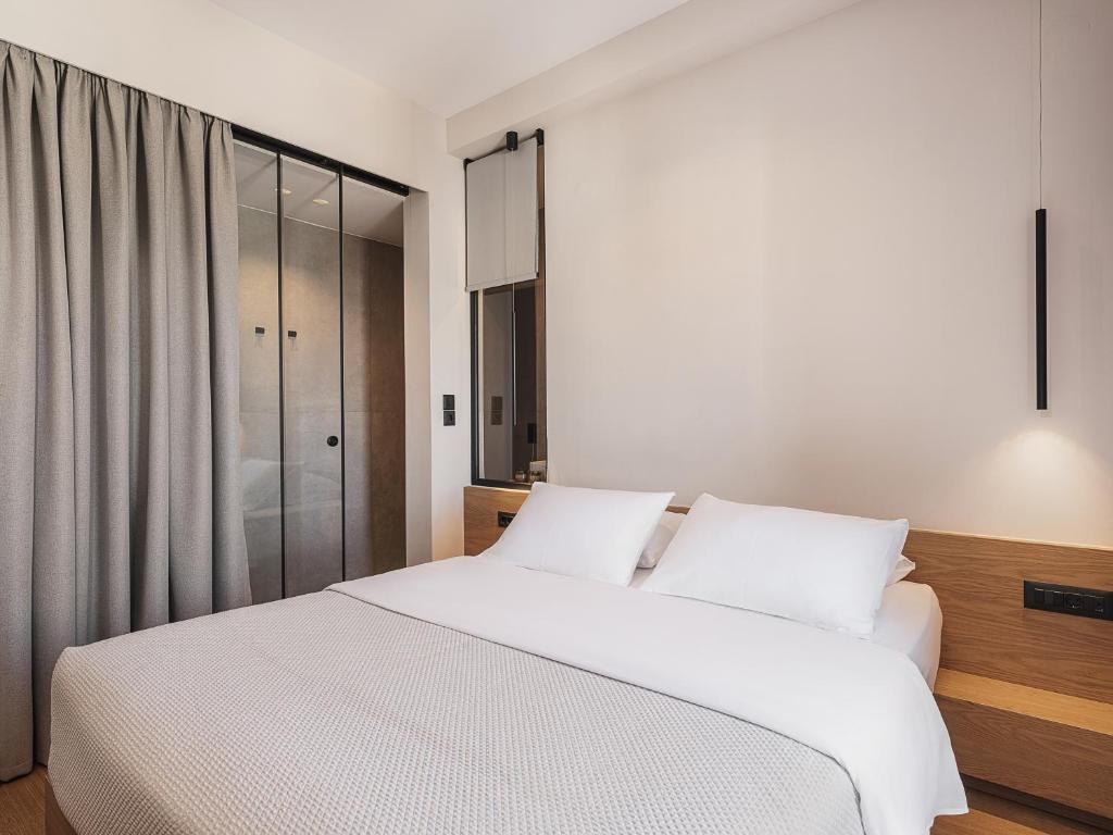 Postel nebo postele na pokoji v ubytování Theofilos City Hotel