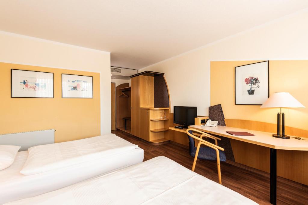 Postel nebo postele na pokoji v ubytování ARVENA Kongress Hotel - Hotel in der Wagnerstadt