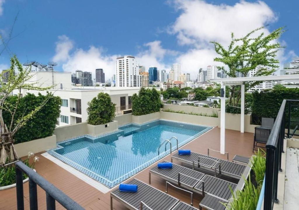 a swimming pool on the roof of a building at Ramada Tenn Ekamai in Bangkok