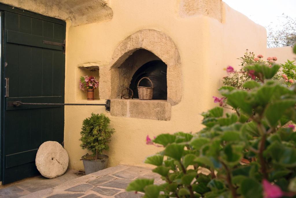 a building with a pizza oven next to a door at Abramis Rooms in Mitáta