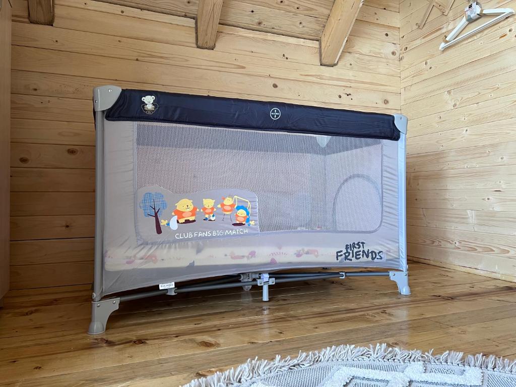 a toy fireplace in a room with a wooden wall at Alfa Omega Žabljak in Žabljak