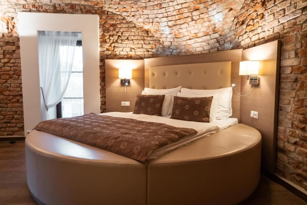 Postel nebo postele na pokoji v ubytování Hotel Sladovna