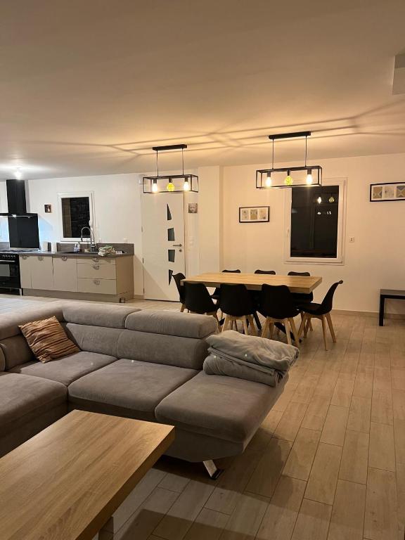 un salon avec un canapé et une table dans l'établissement Escapade à la campagne, à Sottevast