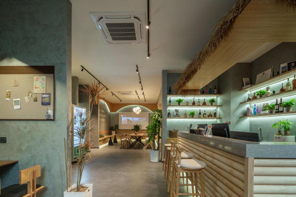 a restaurant with a bar and a dining room at Demba Inn- Shanghai Xintiandi Yuyuan Garden The bund store in Shanghai