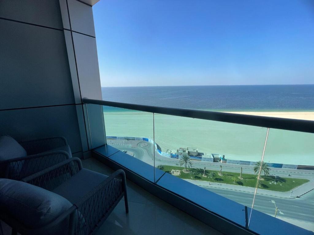 a view of the ocean from a room with a window at Beachfront gem, waves and sunset in Ajman 