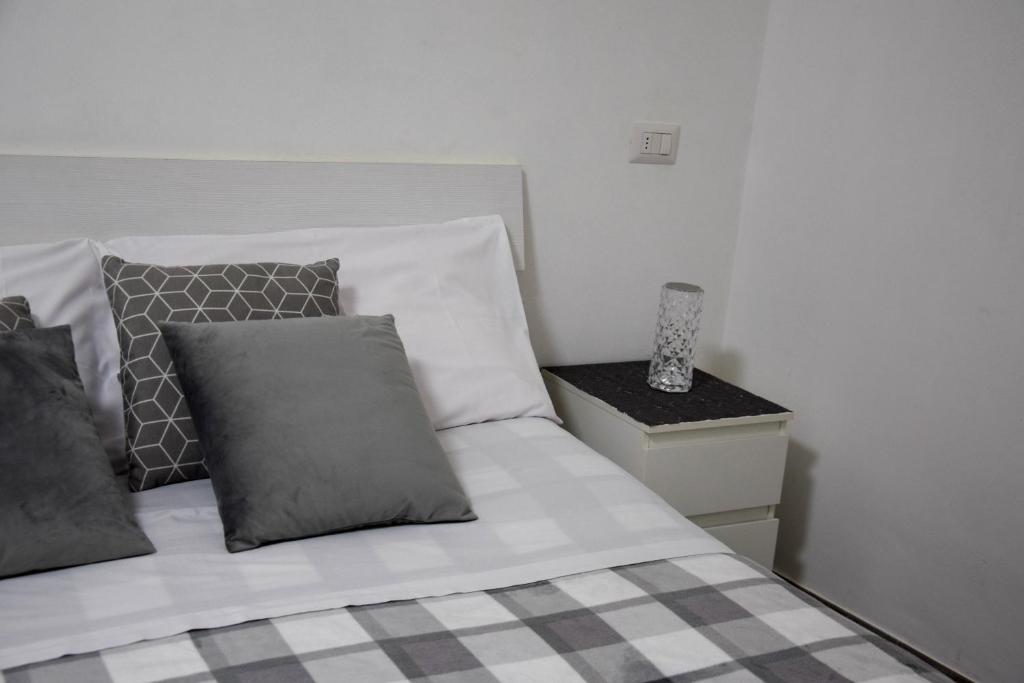 a bedroom with a bed with pillows and a night stand at B&B Claustro Mirti in Altamura