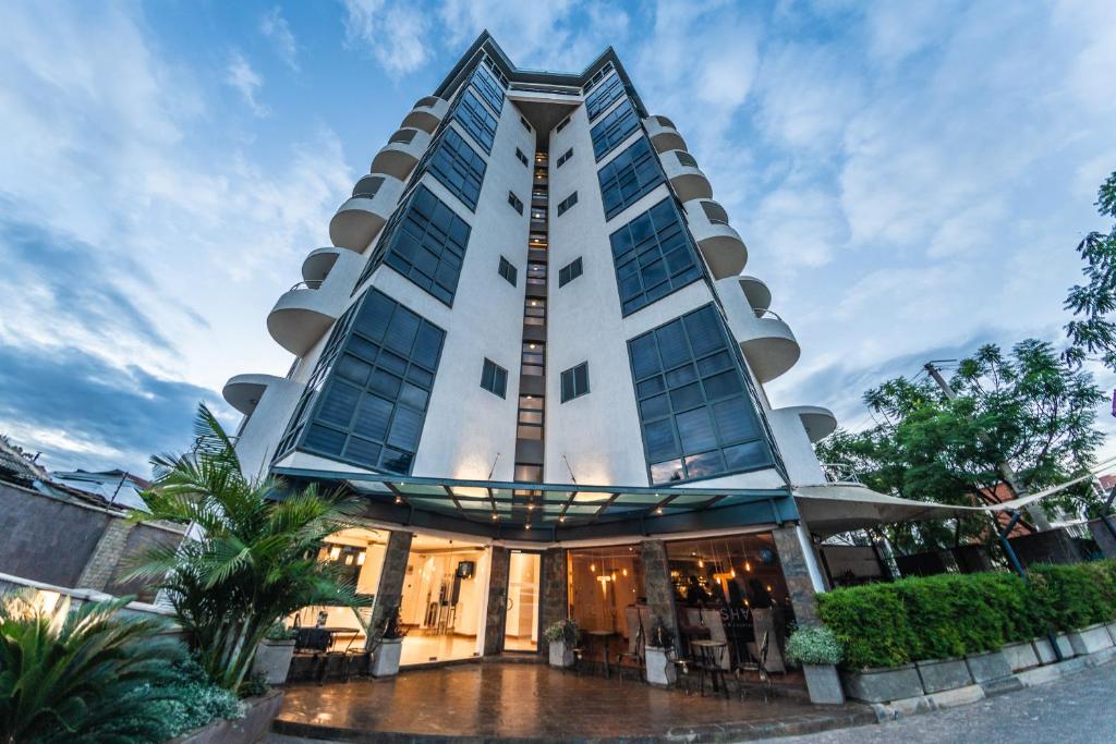 a tall building with a lot of windows at The Lofts on Wood Avenue in Nairobi