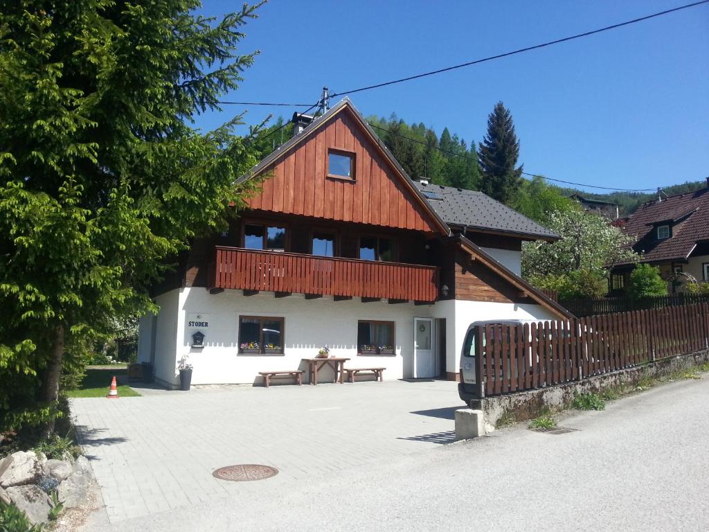 a large white building with a red roof at Pension Stoder in Hinterstoder