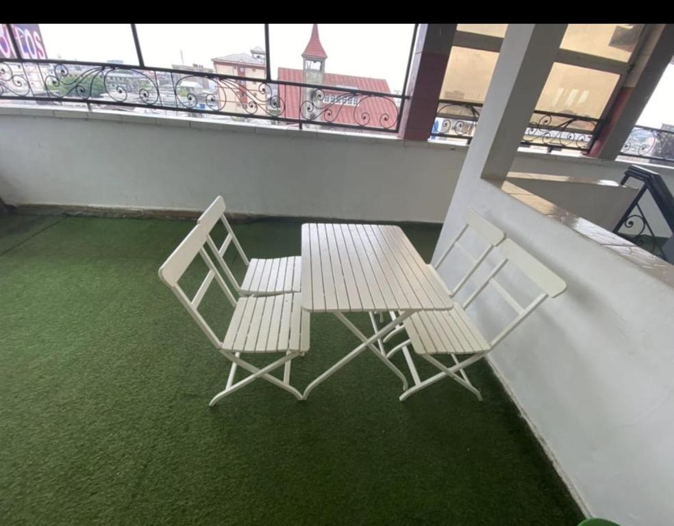 two chairs and a table on a balcony at Complexe A8CLOS in Douala
